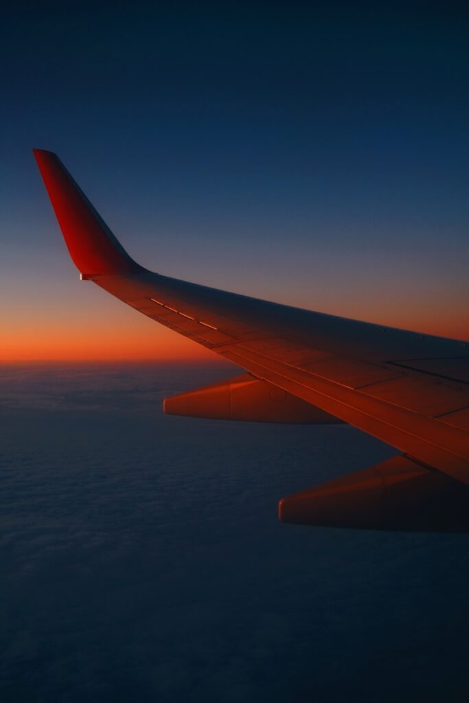 the wing of an airplane as the sun sets